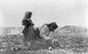 Turkey / Armenia: An Armenian woman kneeling by the corpse of her child just outside Aleppo (Haleb), Syria, during the Armenian Genocide, c. 1915